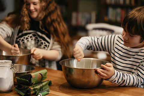 children mixing ingredients in large bowls