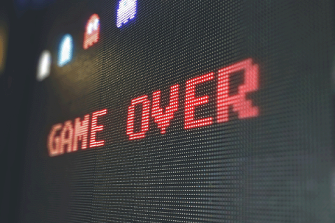 game over computer screen with pac-man ghosts above