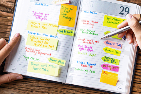 open planner with appointments on sticky notes