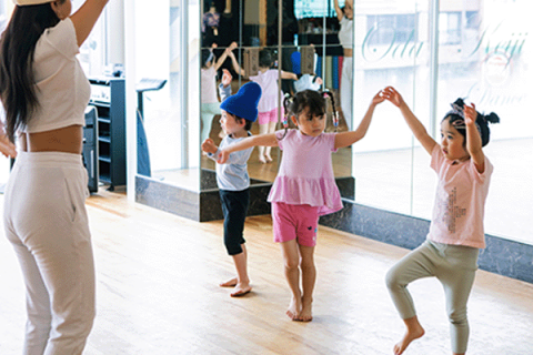 tiny children being taught to dance