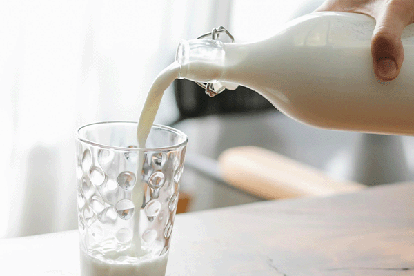 milk being poured into a glass