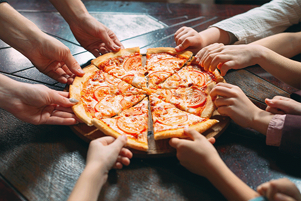 hands grabbing at pizza slices