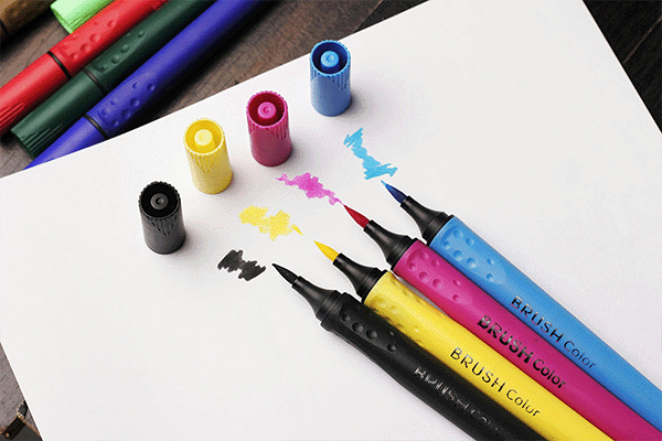 CMYK colored brush tip markers