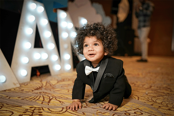 crawling toddler in formal attire